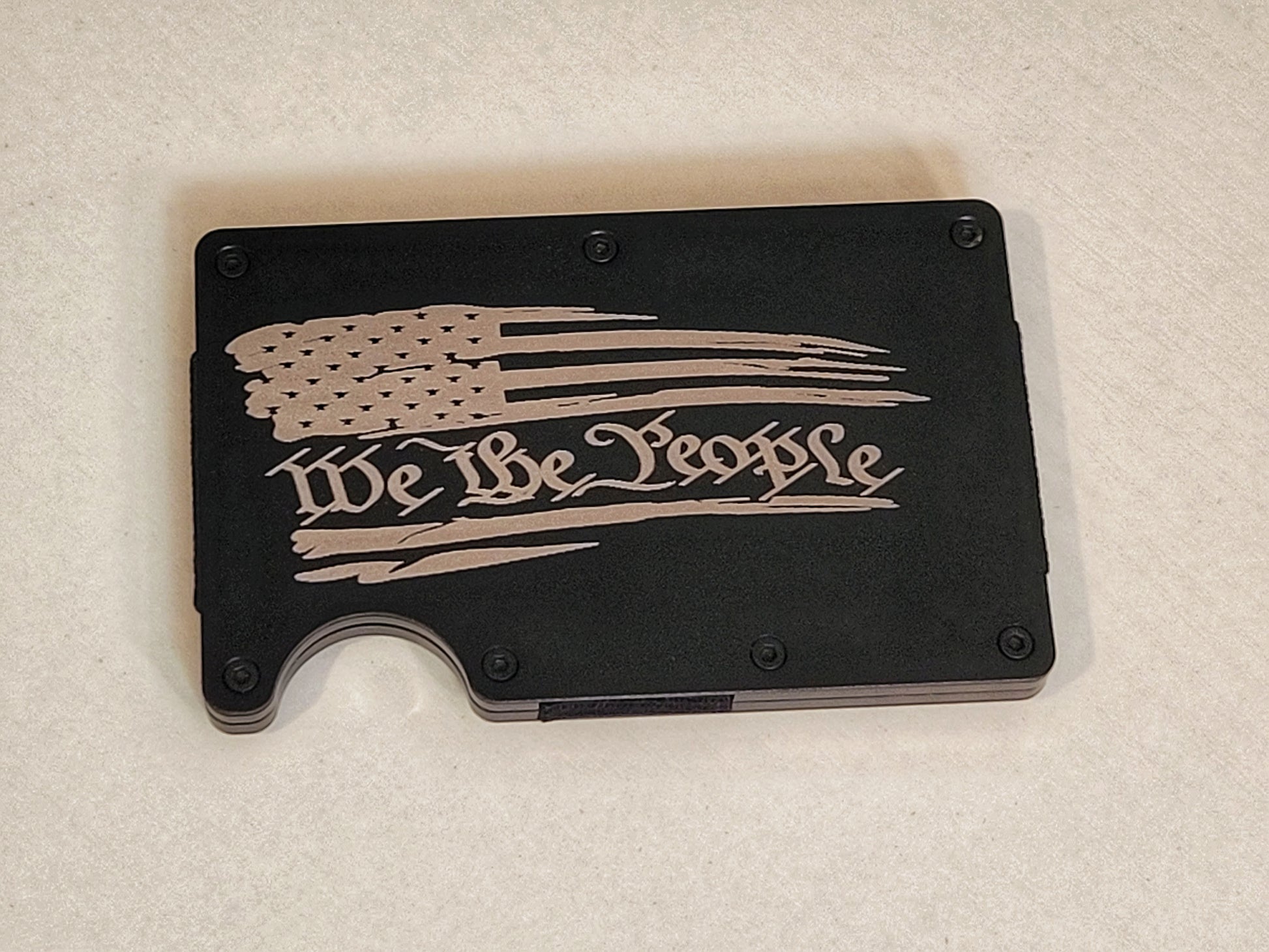 We The People with tattered flag, gray slim wallet